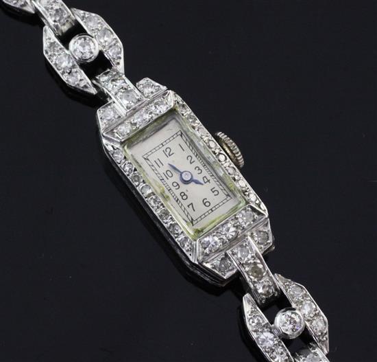 A ladys 1940s/1950s platinum and diamond set cocktail watch, 6.5in.